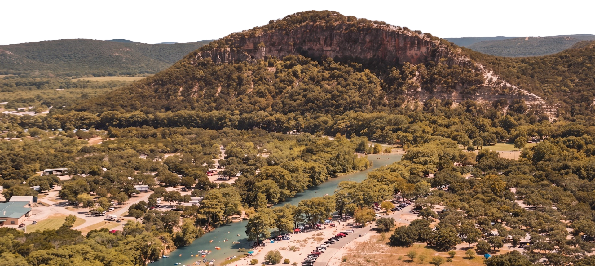 The Frio River winding through Frio Canyon at first light, limestone bluffs glowing gold